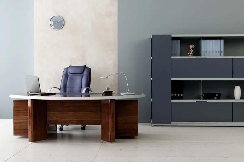 Private office with gray accent walls and a wood desk