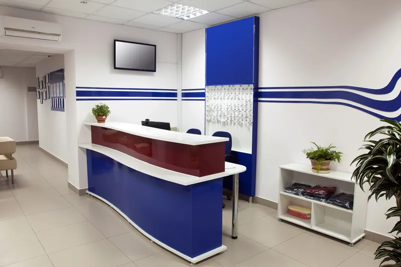 Reception area with blue accent stripes painted across white walls